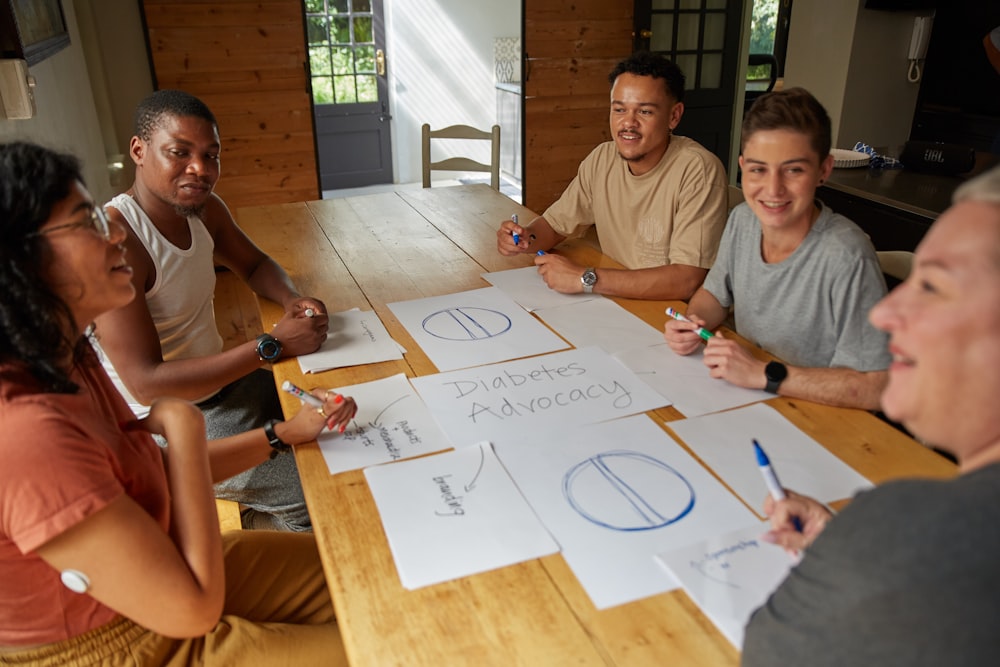 a group of people sitting around a wooden table