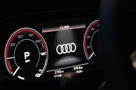Technician performing SCN coding on an Audi dashboard with high-tech equipment.