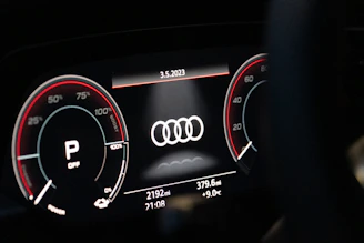 Diagnostic equipment connected to an Audi dashboard showing detailed error codes.