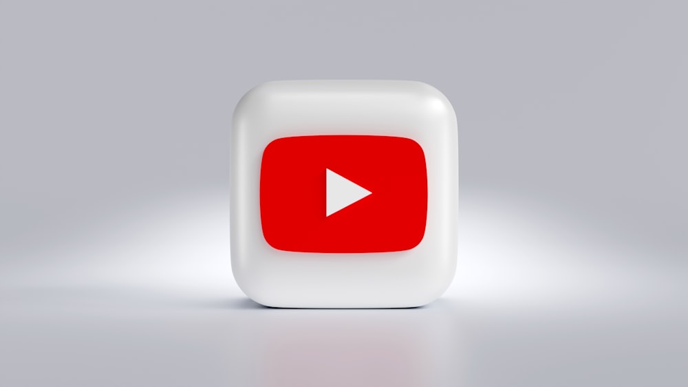 a white square button with a red arrow on it