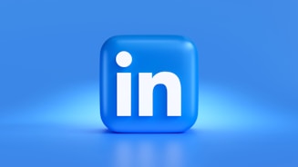 A 3D representation of the LinkedIn logo featuring a rounded blue square with the letter 'in' prominently displayed in white. The background is a gradient of blue hues, providing a clean and professional appearance.