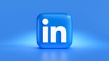 A vibrant LinkedIn logo with a subtle network background.