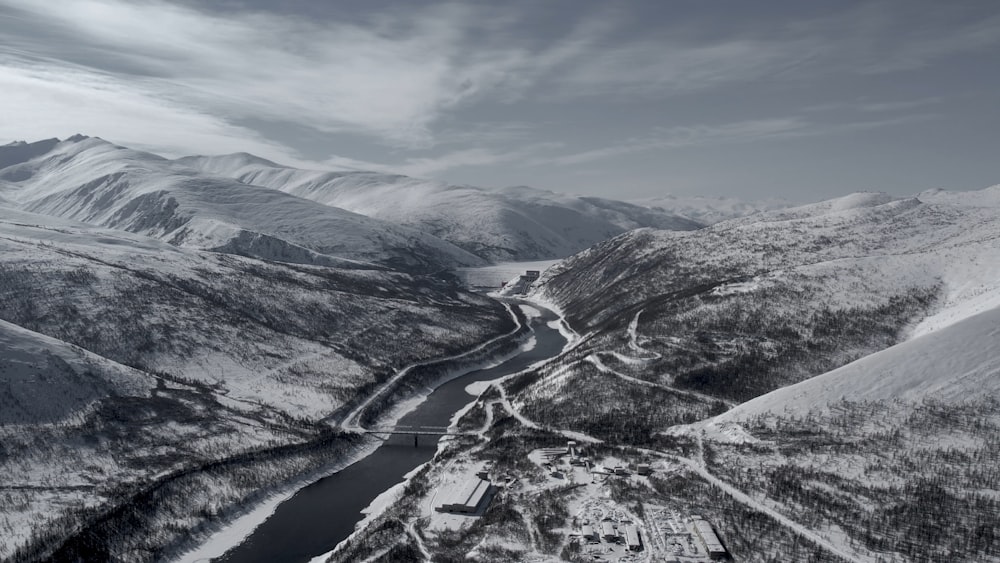 a black and white photo of a snowy mountain range