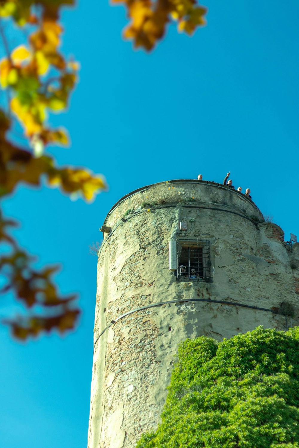 a tall tower with a bunch of people standing on top of it