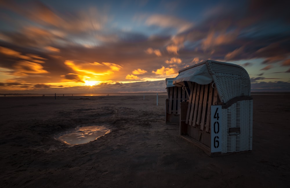 a row of beach huts sitting on top of a sandy beach