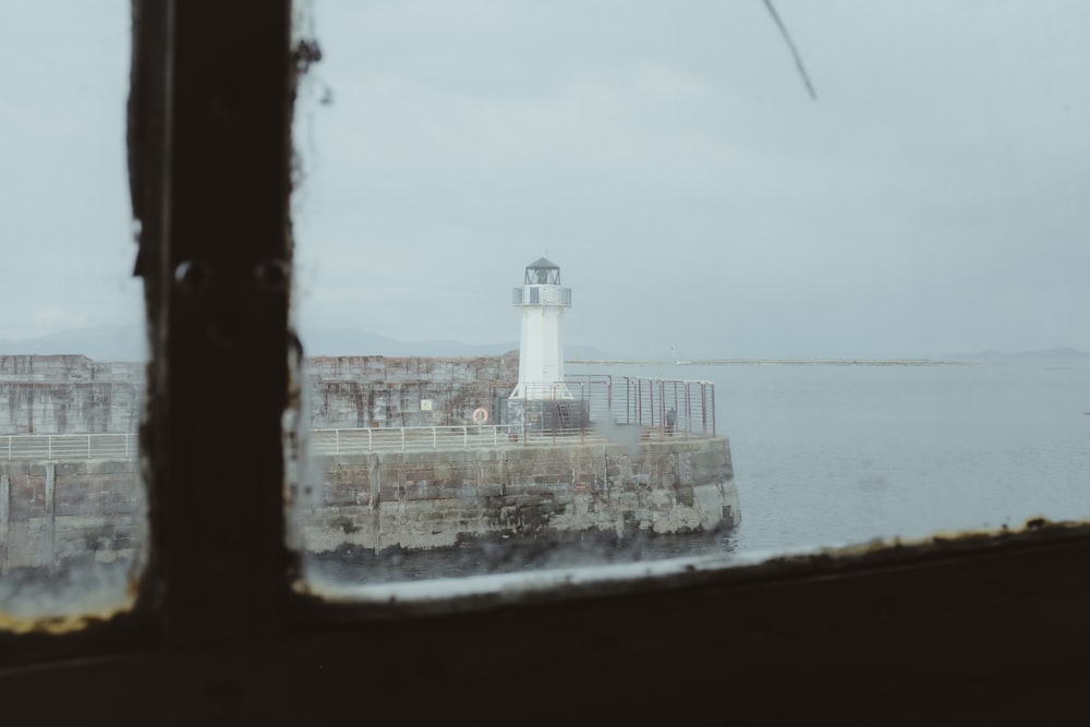 a view of a light house through a window