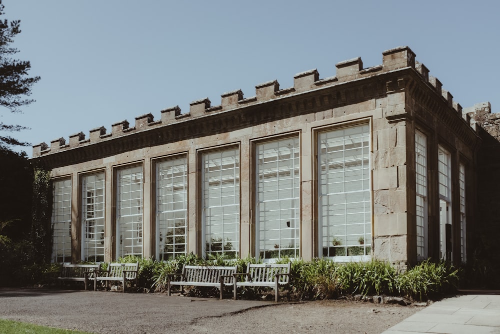 a building with a lot of windows and a bench in front of it