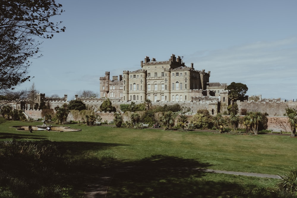 a large castle with a lot of trees in front of it