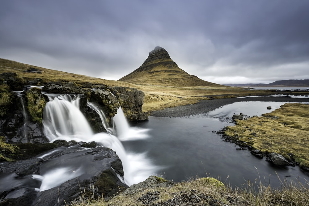 a mountain with a waterfall in the middle of it