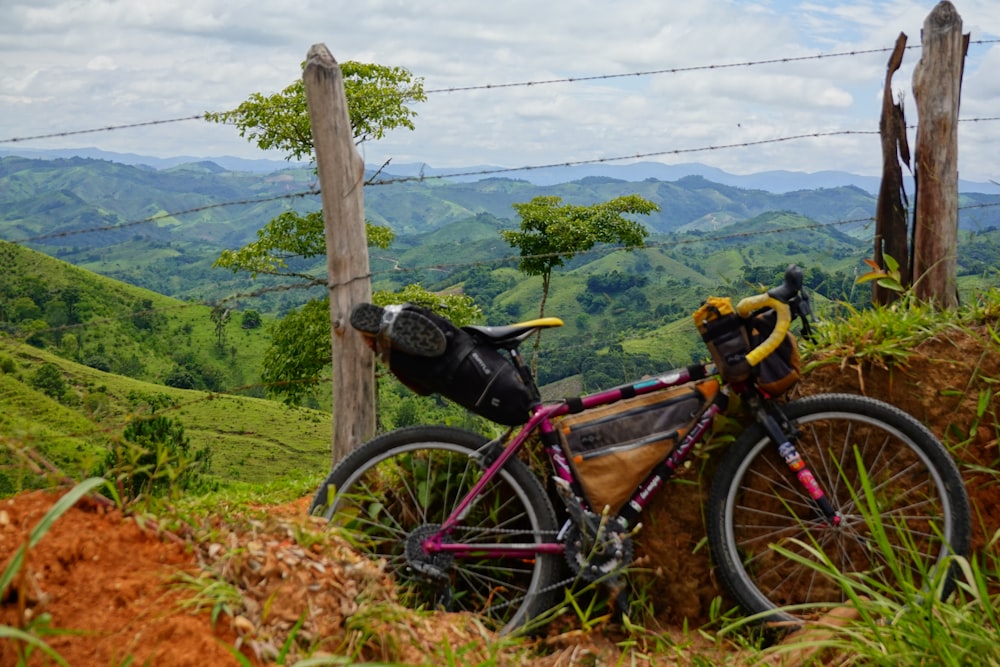 a bicycle parked on the side of a hill