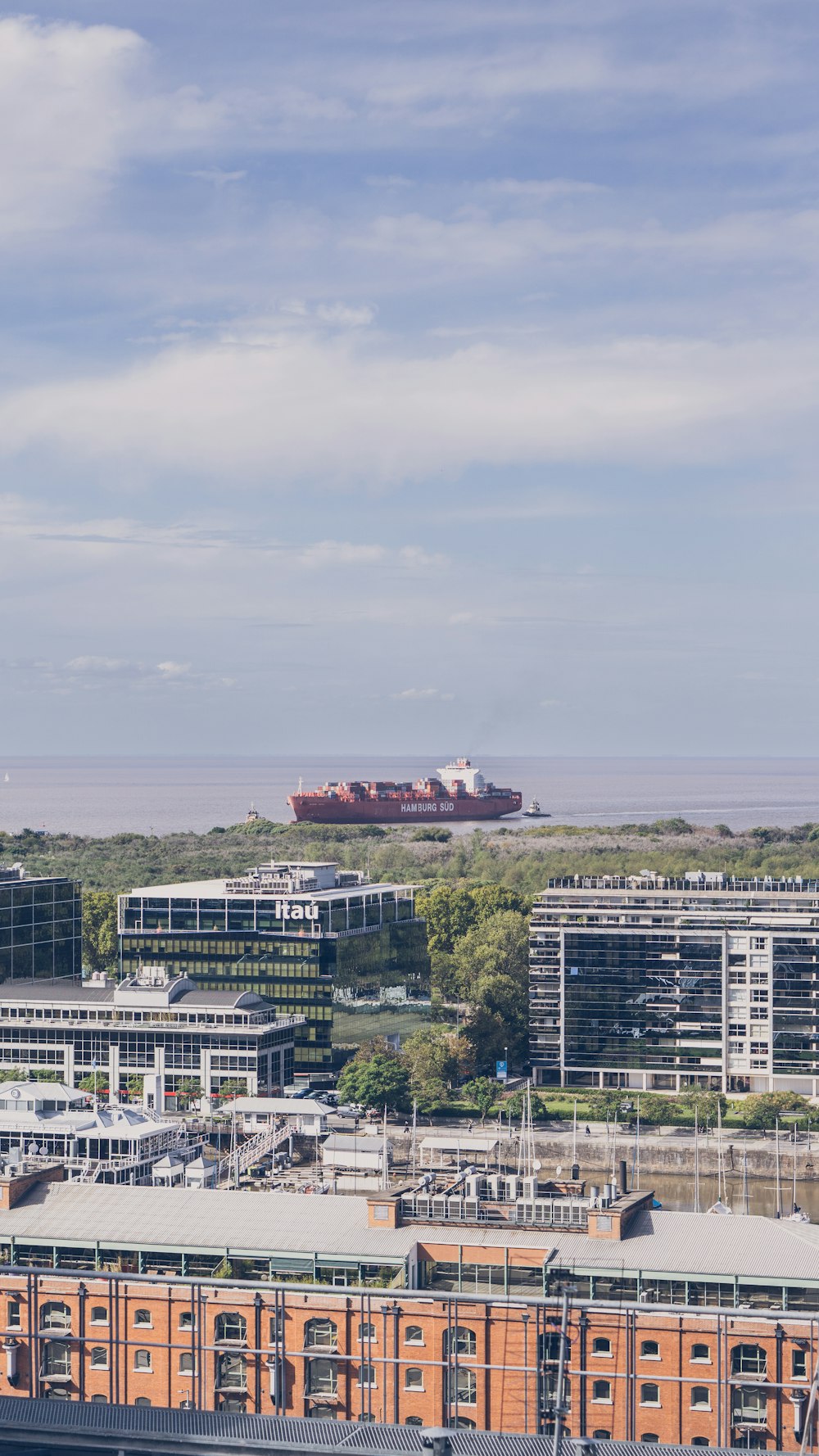 a view of a city with a large ship in the distance