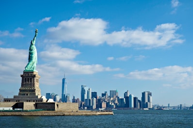 a view of the statue of liberty from across the water