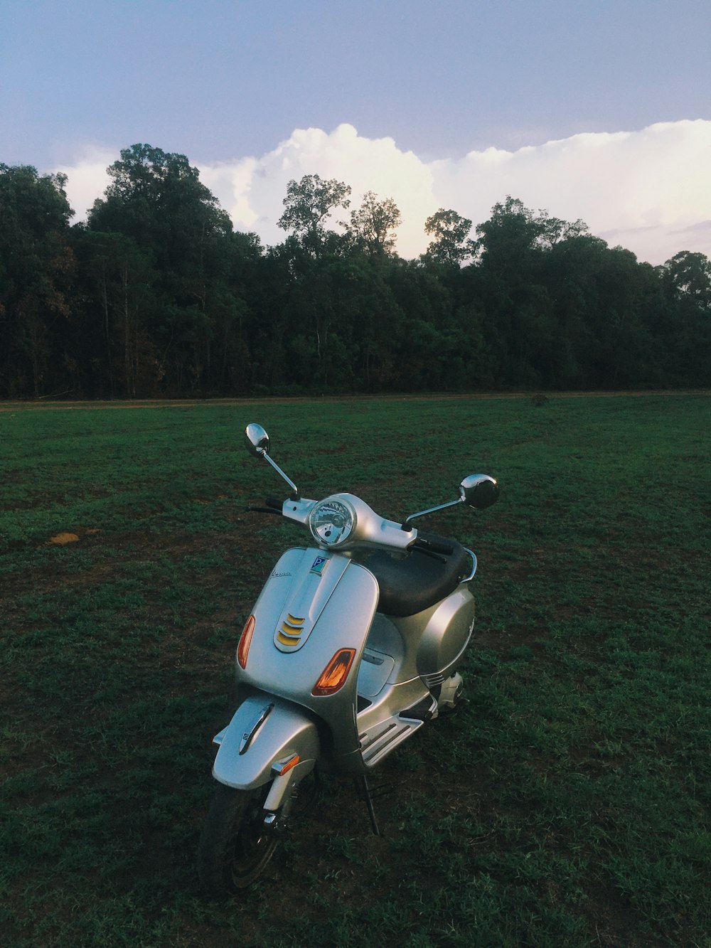 a scooter is parked in the middle of a field