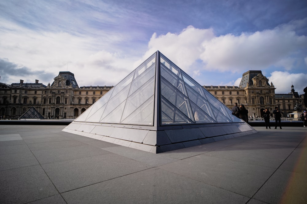 a large white pyramid sitting in front of a building