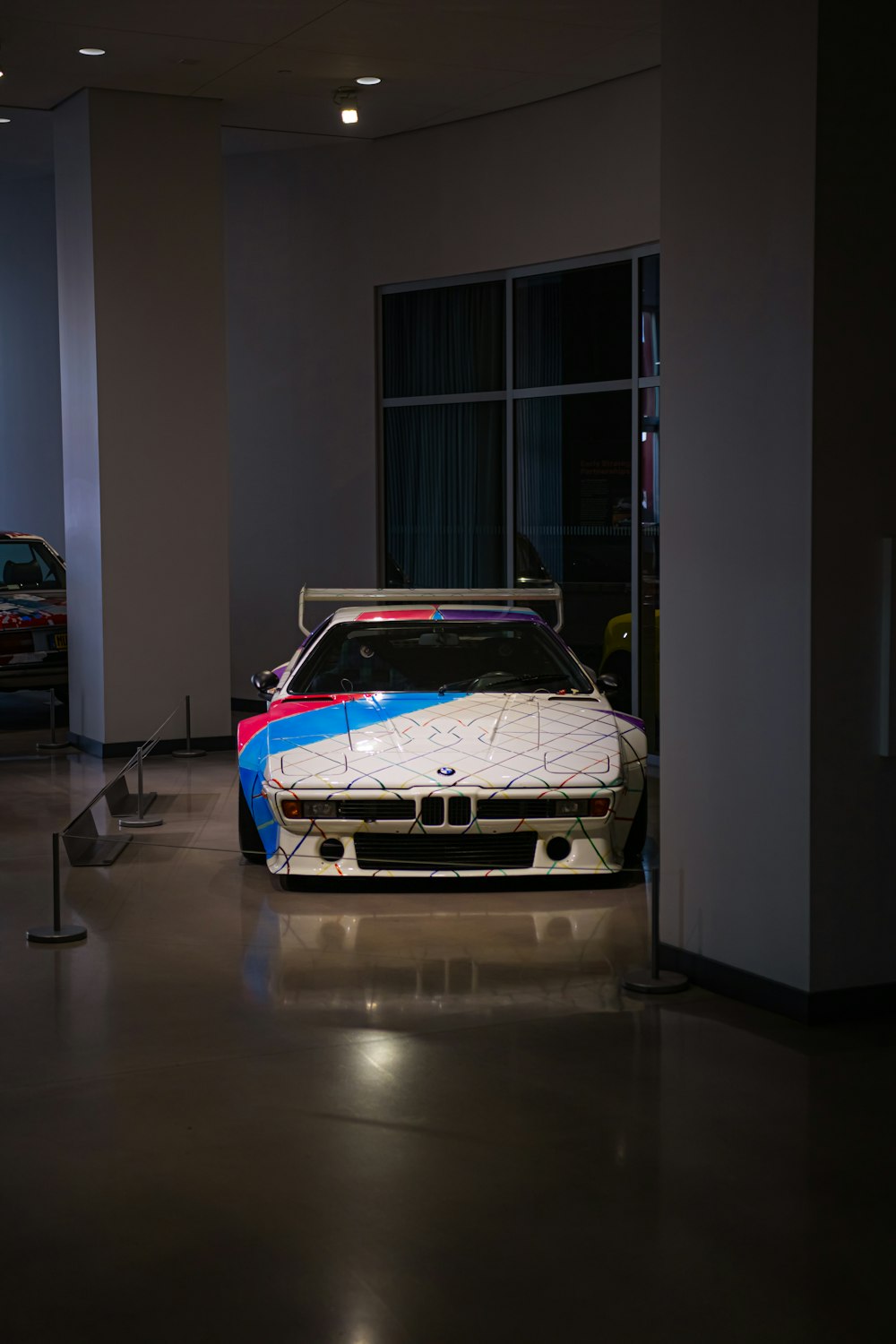 a bmw race car parked in a garage