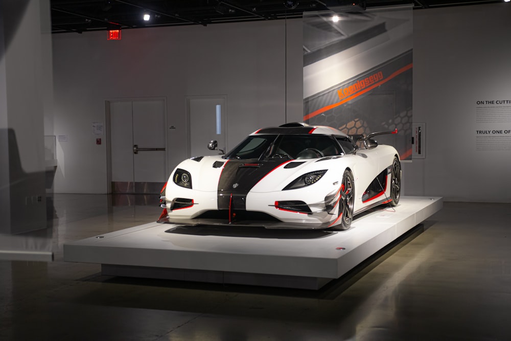 a white and black sports car on display in a museum