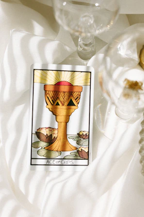 Close-up of the Page of Cups tarot card with soft watercolor details.