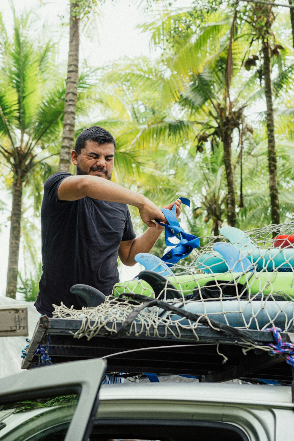 a man standing on top of a truck filled with rafts