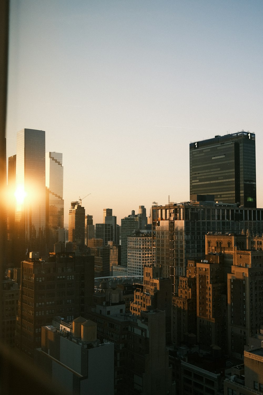 a view of a city at sunset from a window