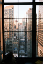 Beautiful city skyline seen through a large window, symbolizing real estate opportunities.