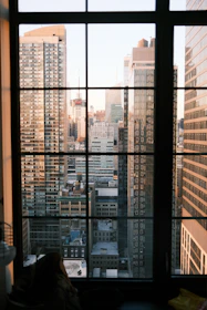 Beautiful city skyline seen through a large window, symbolizing real estate opportunities.