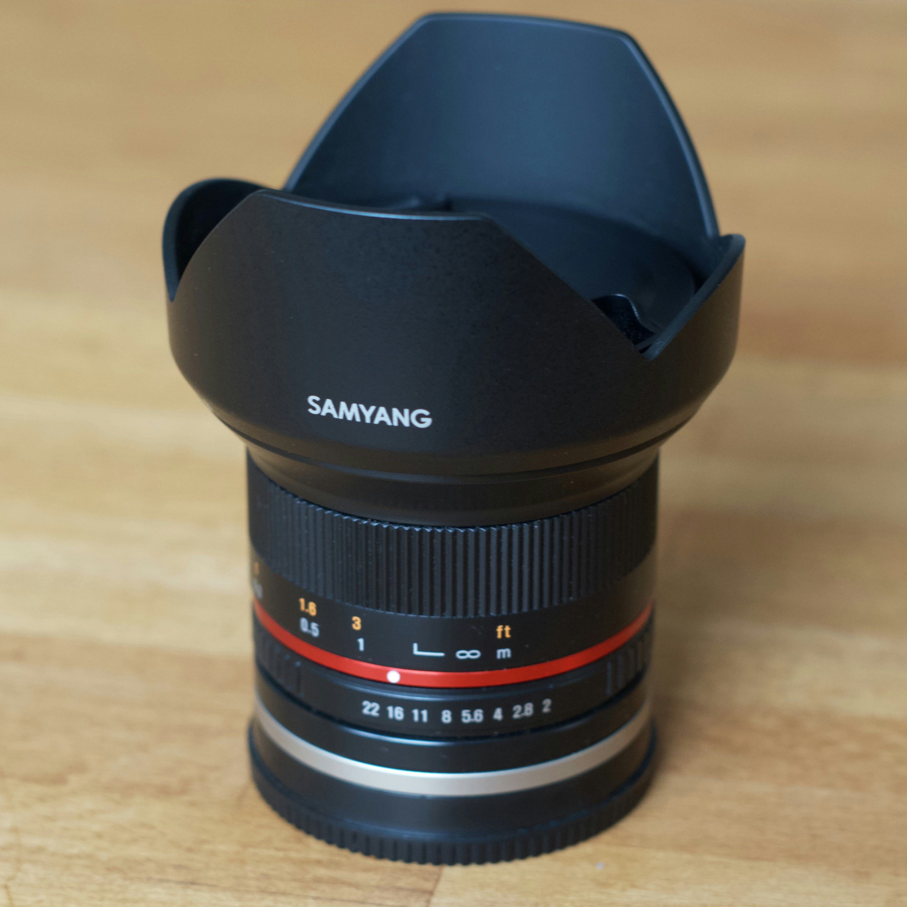 a camera lens sitting on top of a wooden table