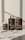 Three brown bottles with white caps are arranged on a light surface. The bottles are labeled as 'Act + Acre' and include 'Cold Processed Scalp Detox,' 'Cold Processed Hair Cleanse,' and 'Cold Processed Hair Conditioner.' Shadows of nearby objects are visible on the surface.
