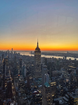 A breathtaking cityscape at sunset, filled with towering buildings and glowing lights.