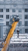 a crane is lifting a building into the air