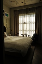 Professional inspecting a bedroom for bed bugs with specialized equipment.