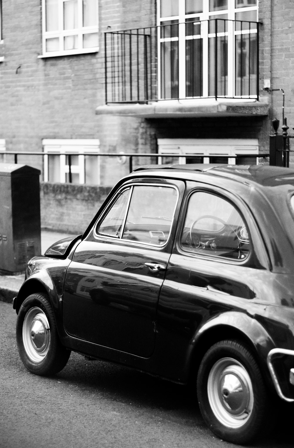 a black and white photo of a small car