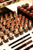 Close-up of colorful lipsticks arranged neatly on a white surface