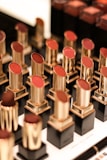 Close-up of vibrant lipsticks arranged on a sleek display