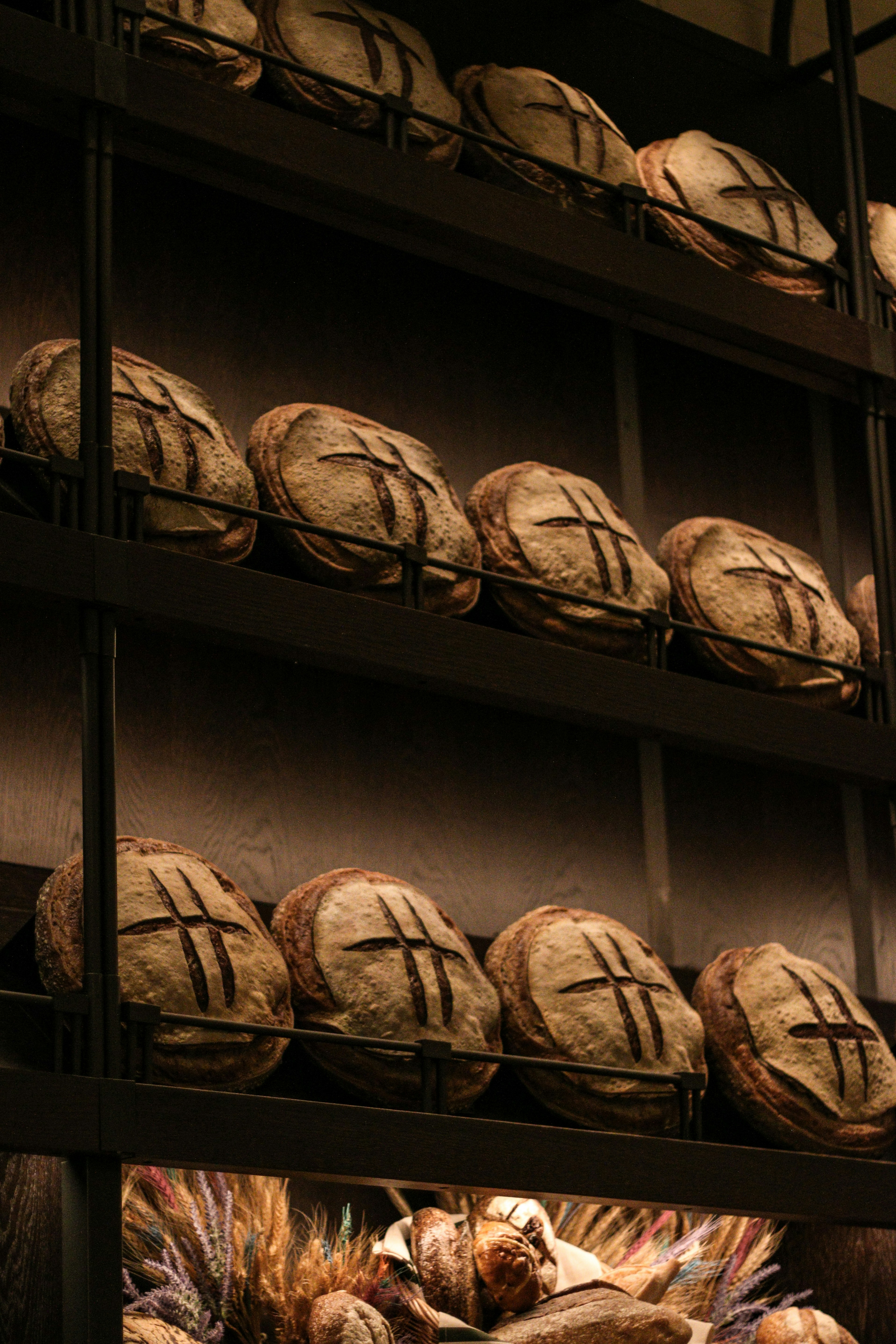 a shelf filled with lots of bread on top of shelves