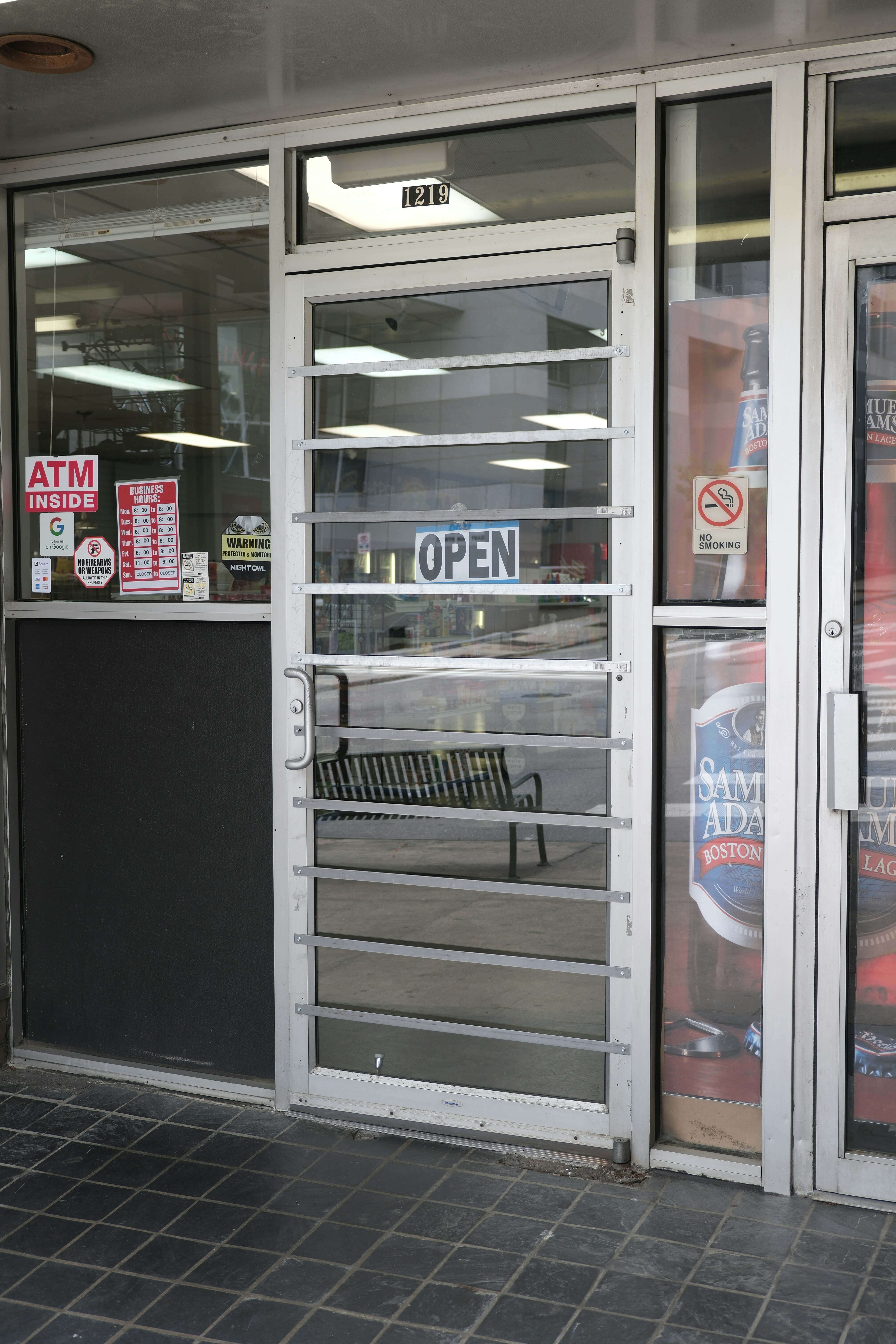 A store front with a bench in front of it photo – Free Door Image on ...