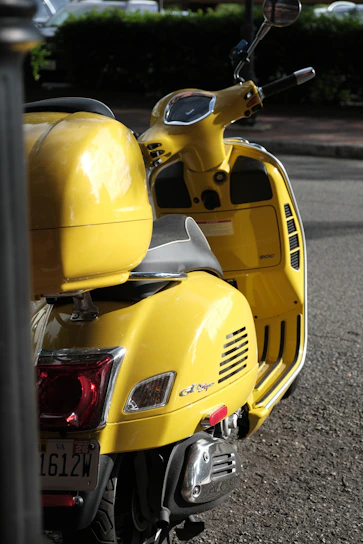 A sleek electric scooter parked on a bustling street in Uttar Pradesh with sunlight reflecting off its polished frame.