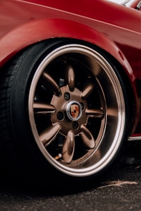 a close up of a red sports car wheel