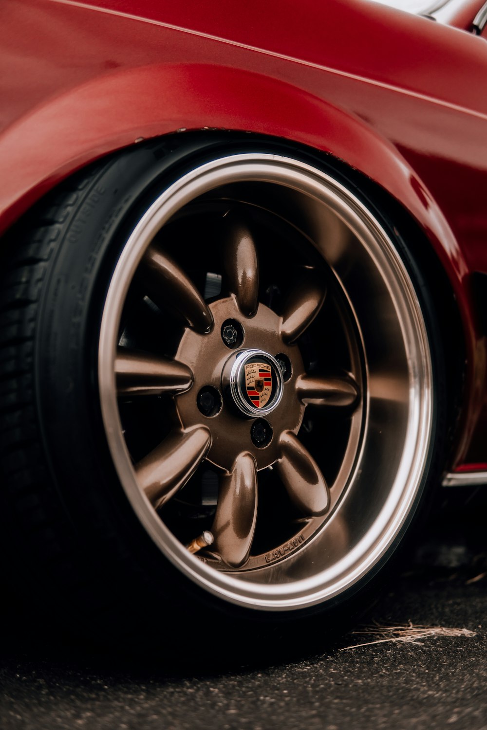 a close up of a red sports car wheel