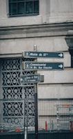 A caricature of a city street where street signs point in confusing directions named after political slogans.