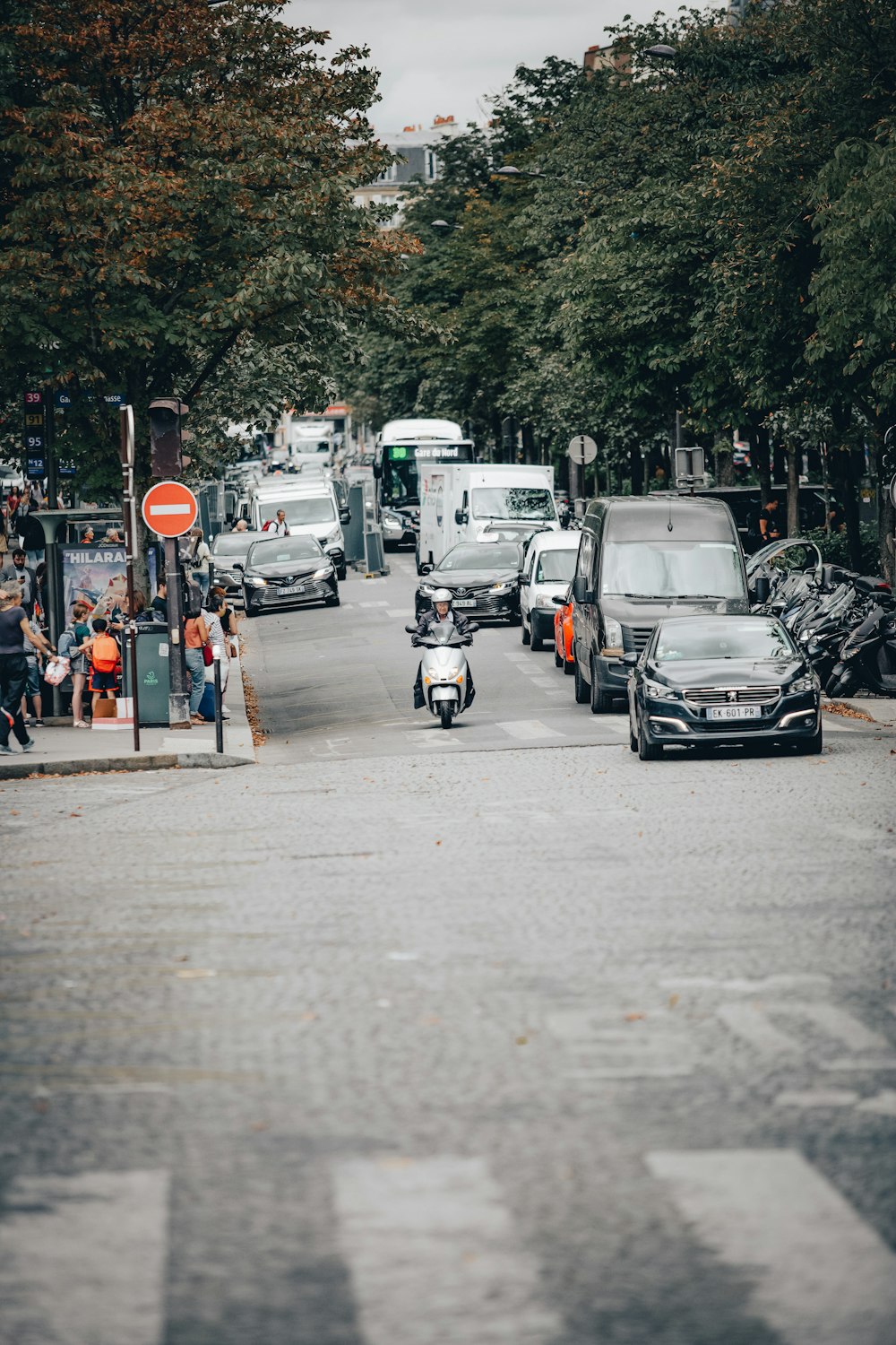 a street filled with lots of traffic next to trees