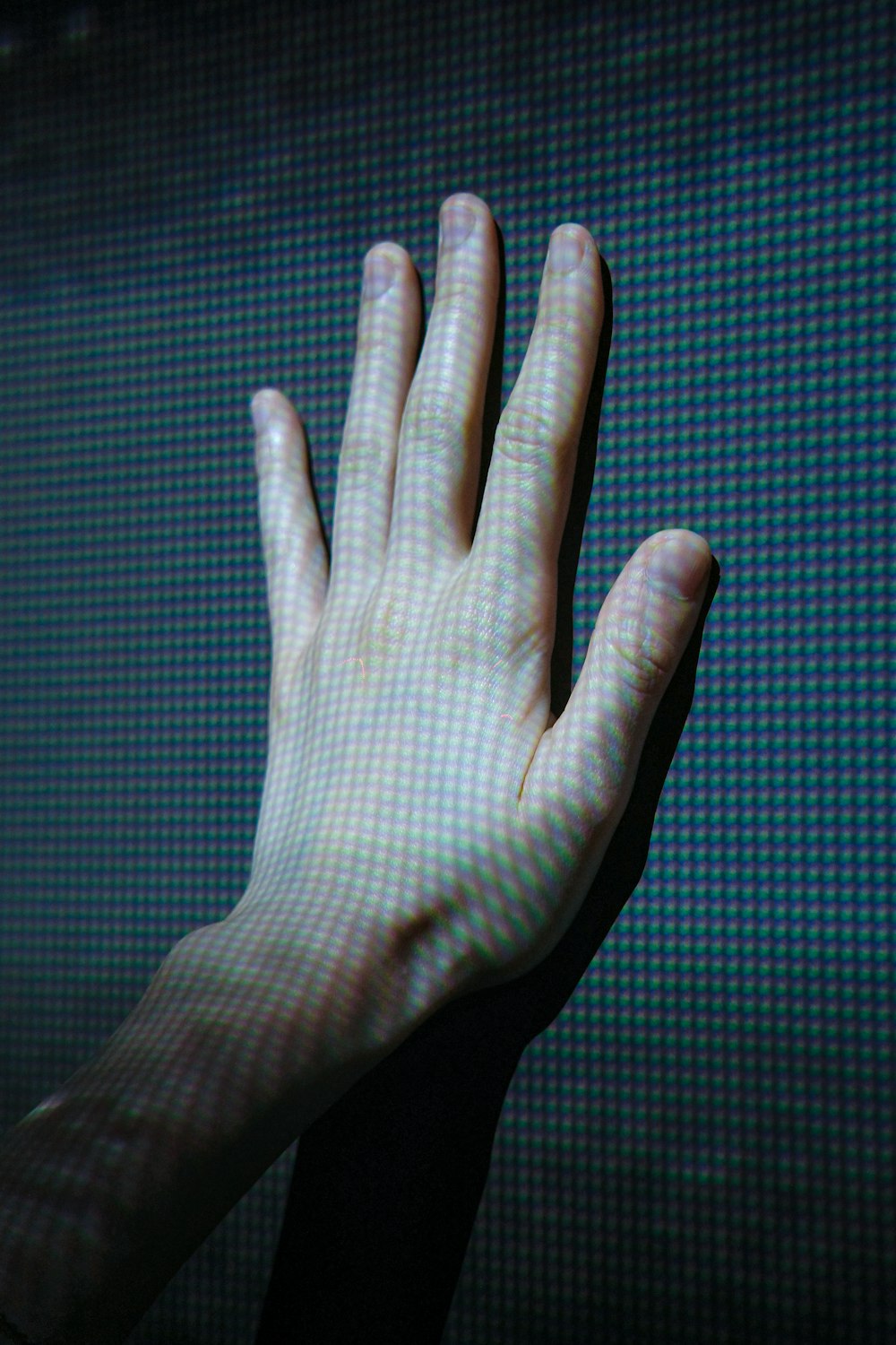 a person's hand reaching up into the air