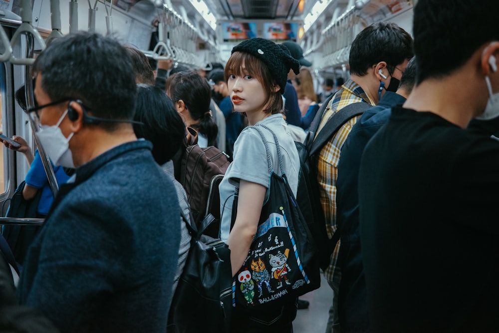 a group of people standing on a subway train