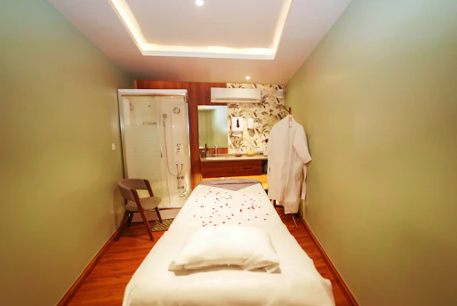 A serene massage room with soft lighting and a client enjoying a calming massage.