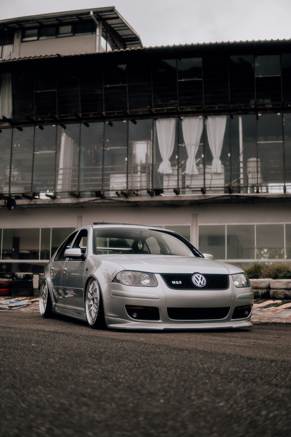 a silver car parked in front of a building