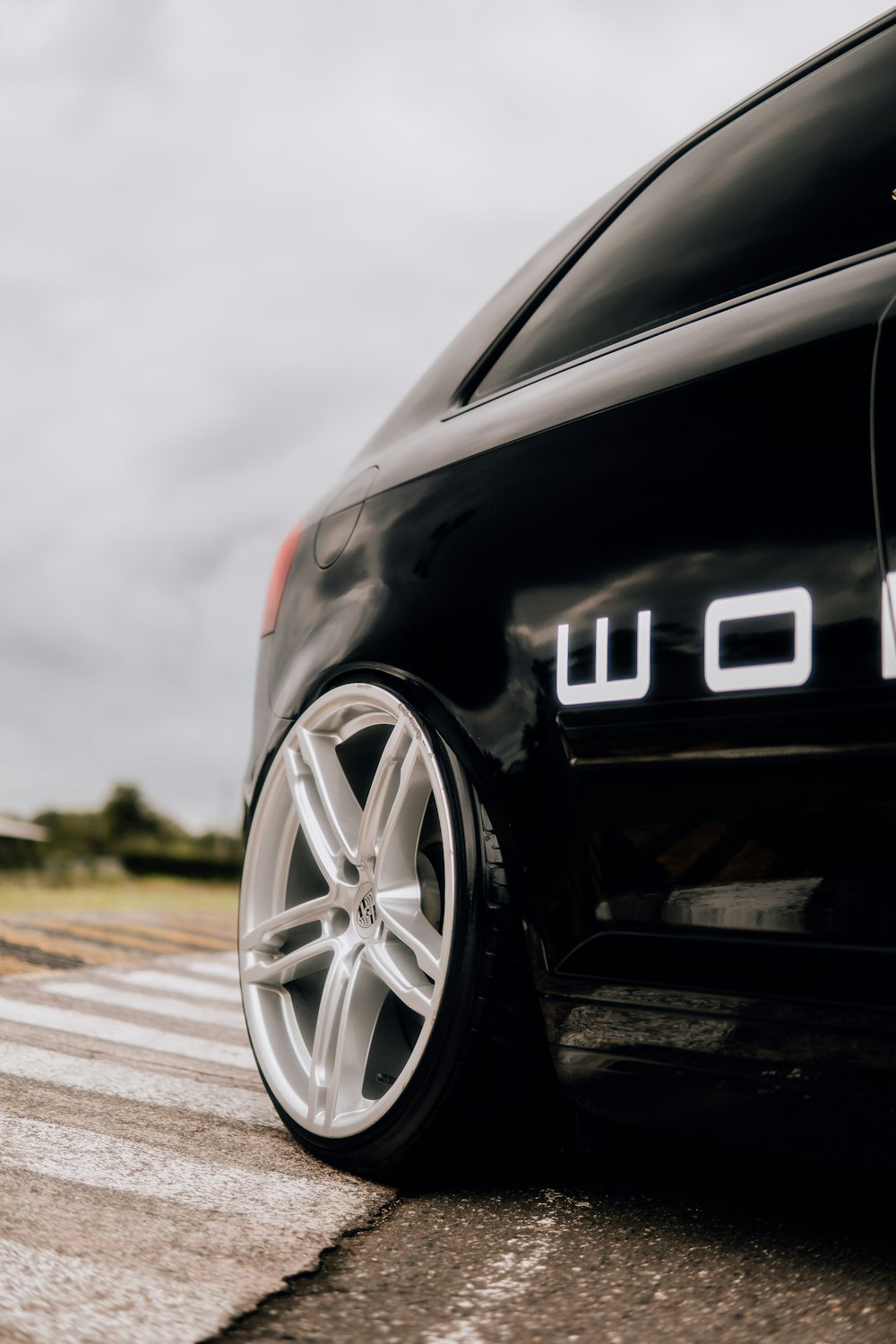 a black car parked on the side of the road