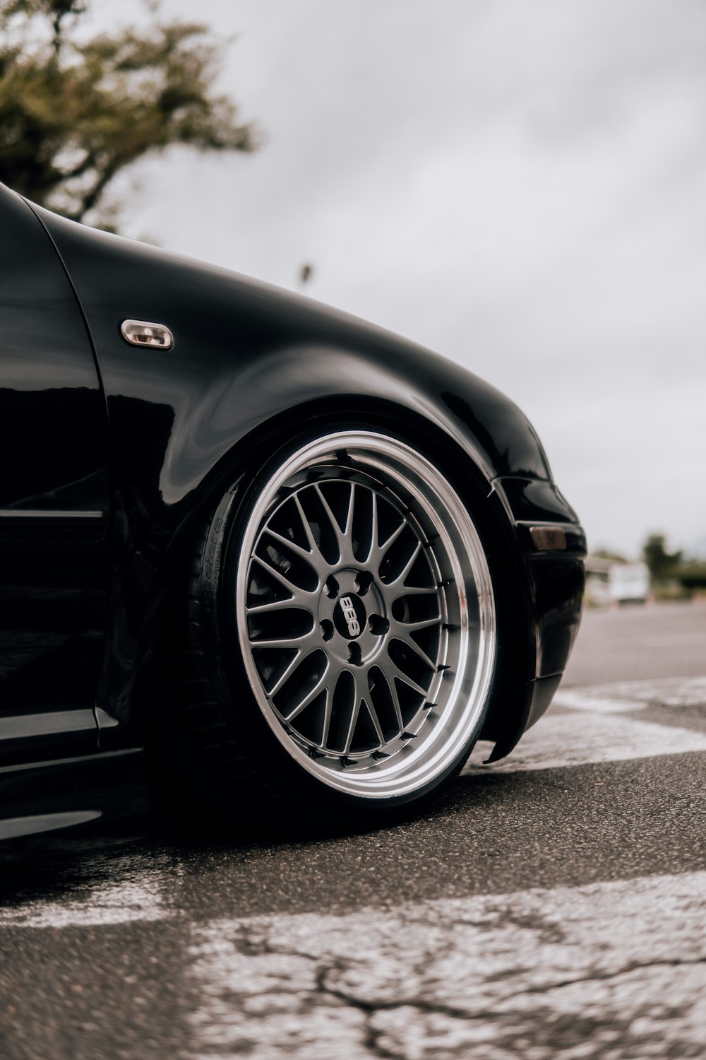 a black car parked on the side of the road