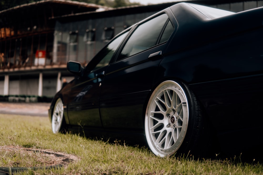 a black car parked on the side of a road