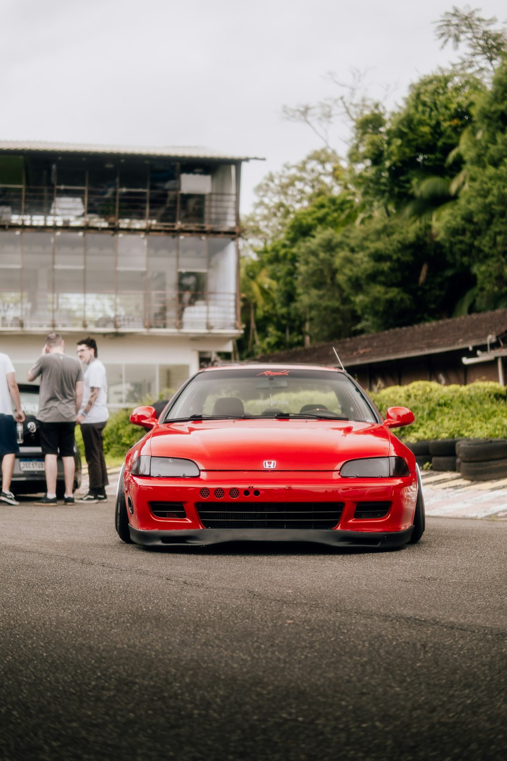 a red sports car parked in front of a house