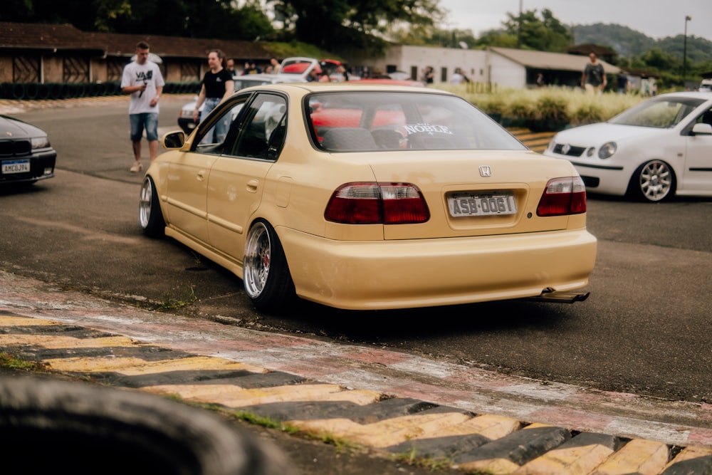 a yellow car parked on the side of the road