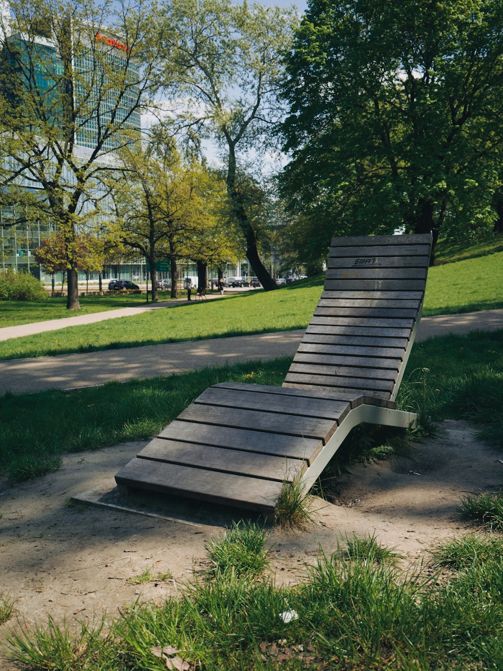 a wooden bench sitting in the middle of a park